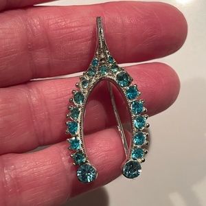 Bogoff blue rhinestone wishbone brooch/pin.